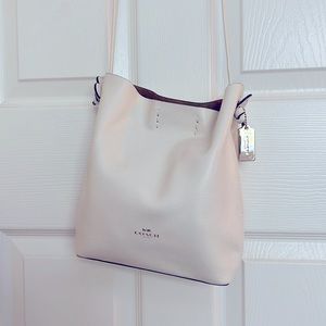 Gorgeous white leather body and white leather cross body strap purse by Coach.